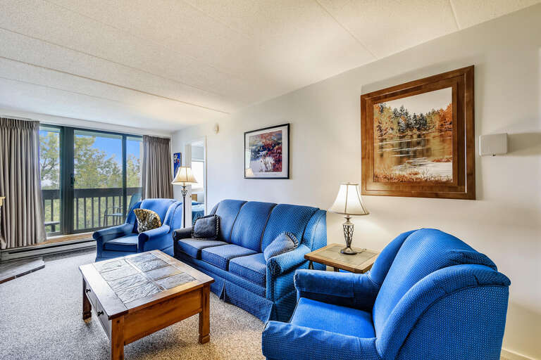 Bright Blue Sofas Balance Beside A Sunny, Spacious Setting, Subtly Lit, Serene Scape Shown