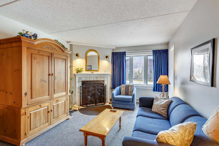 Bright Blue Curtains, Plush Sofa, Polished Wooden Furniture In Living Space