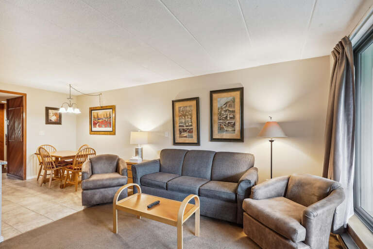 Spacious Living Area With Sofa Set And Dining Table