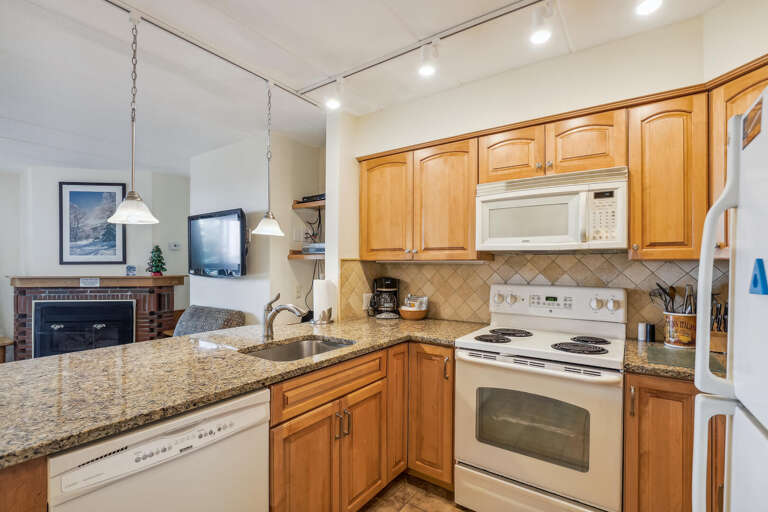 Kitchen Space With Cabinets, Counters, And Classic Cooking Appliances