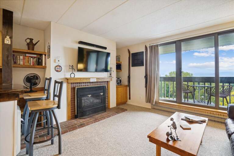 Inviting Interior, Scenic Seaside View Through Balcony Window In Vacation Rental Living Space