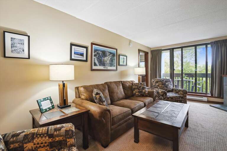 Interior Showing Living Space With Sofas, Coffee Table, And Artwork, Balcony Door Open
