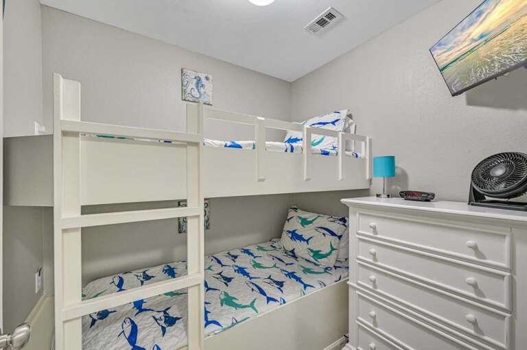 Kid-Approved Bunk Room - With fun bedding, a
cozy layout, and a space to stash all their beach
finds, this room is made for little travelers