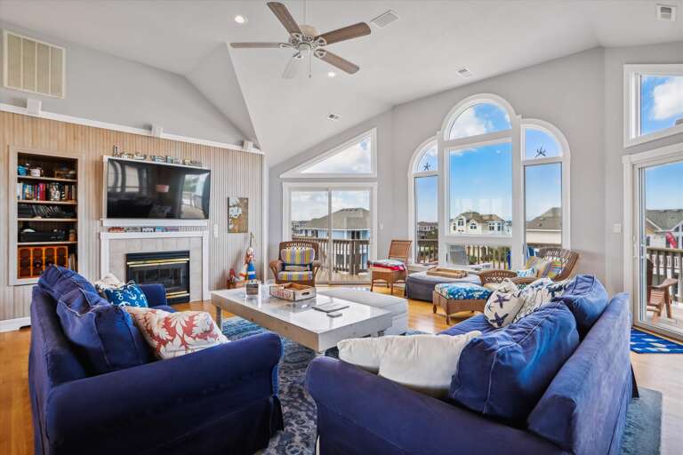 Spacious Living Room With Blue Sofas And Large Windows
