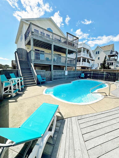 Multi-story Residential Building With Pool And Deck Chairs Multi-story Residential Building With Pool And Deck Chairs