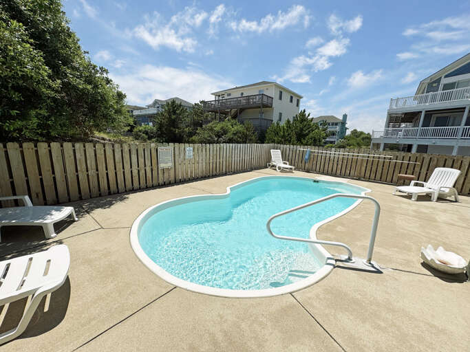 Swimming Pool With Deck Chairs At Vacation Rental