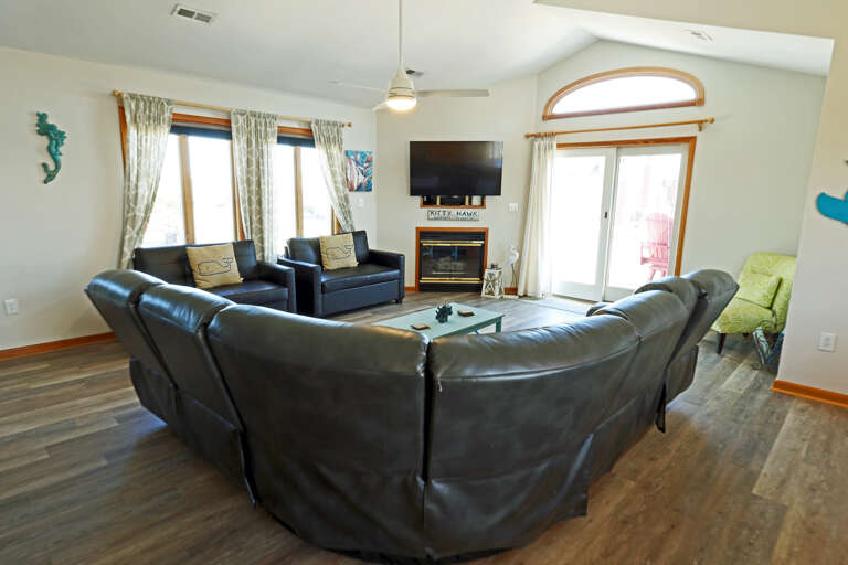 Living Room With Sofas, Television, And Windows