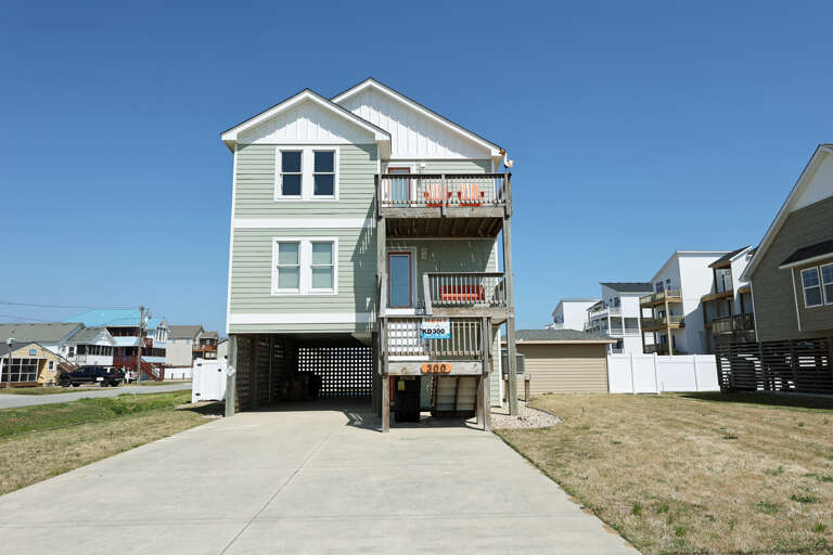 Three-story Blue House With Driveway And Balcony