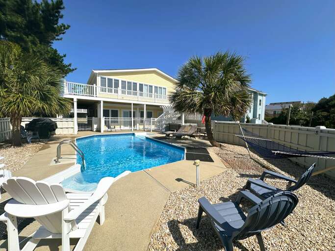 Blue Pool By Bright Building, Loungers Lining Leisurely