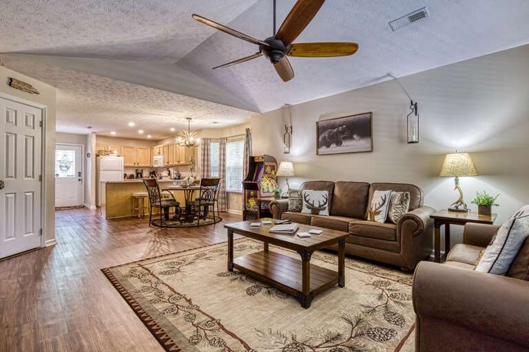 Spacious Living Room Linked To Kitchen, Lit With Lamps And Natural Light