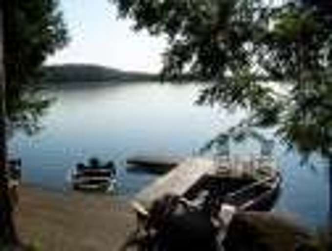 Lakeside View With Dock And Boats