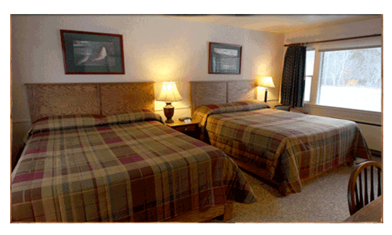 Cozy Twin Bedroom With Plaid Bedding And Warm Lighting