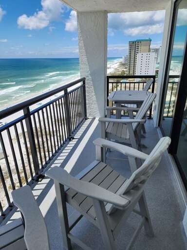 Balcony View Of Beach With Breezy Blues And Whites