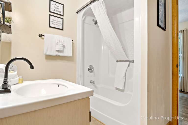 The 1st full bathroom has a shower and tub combo