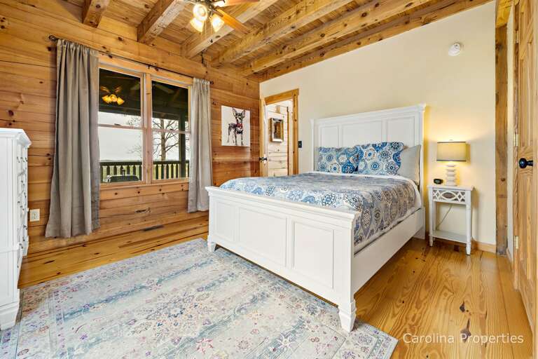 Main level bedroom with a queen bed