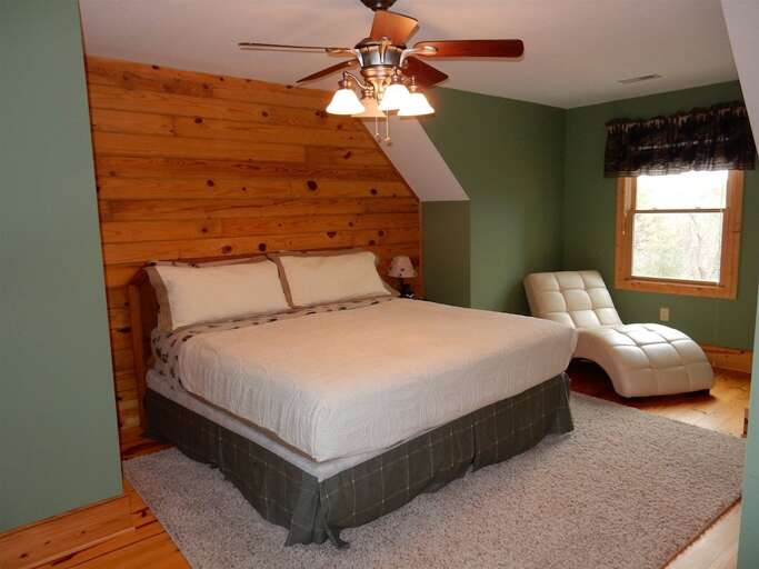 Upstairs bedroom features a king sized bed