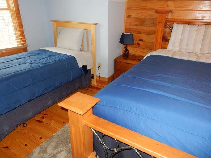 Upper level bedroom with 2 twin beds and a queen bed