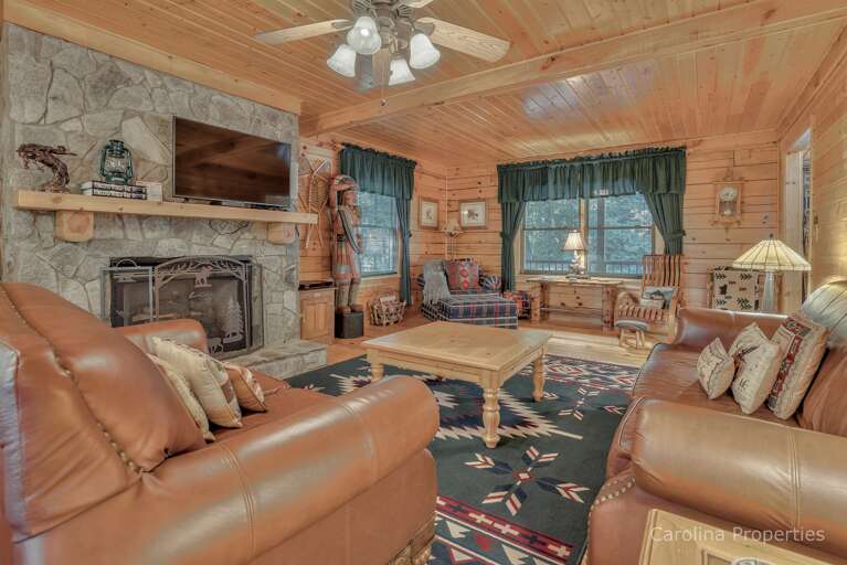 Large stone, gas log fireplace in the living room 