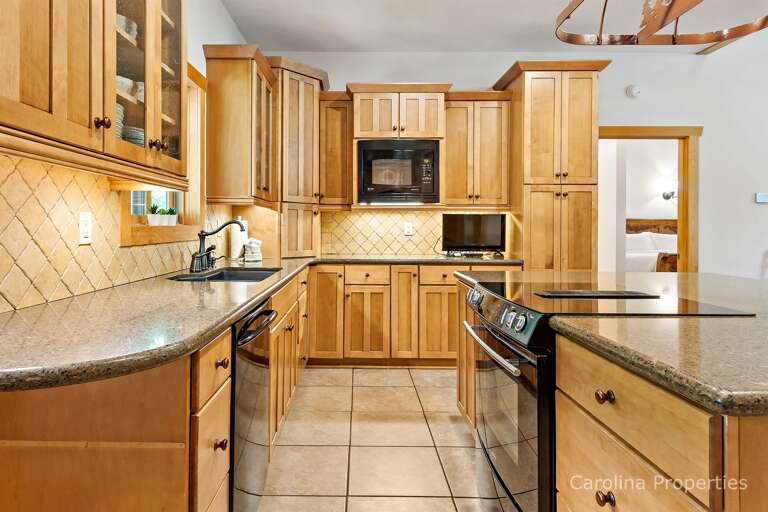 In addition to the smooth-top range, dishwasher with hidden controls, and microwave, there is a TV