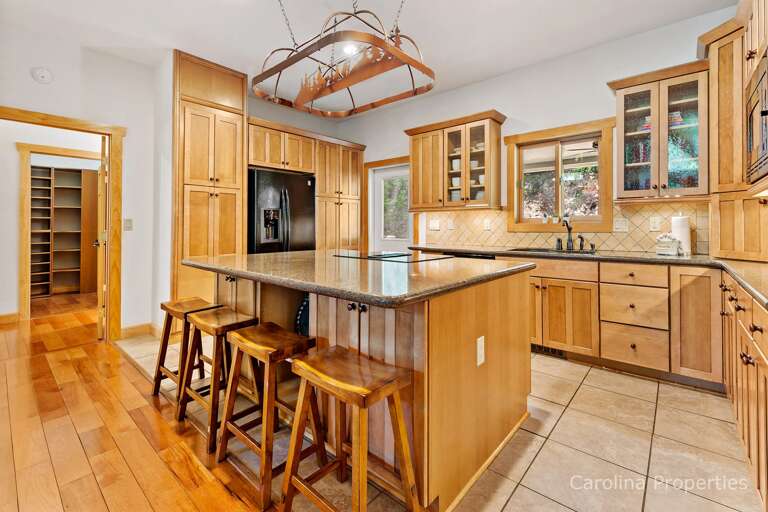 The center island has a beautiful granite counter and a breakfast bar with seating for 4