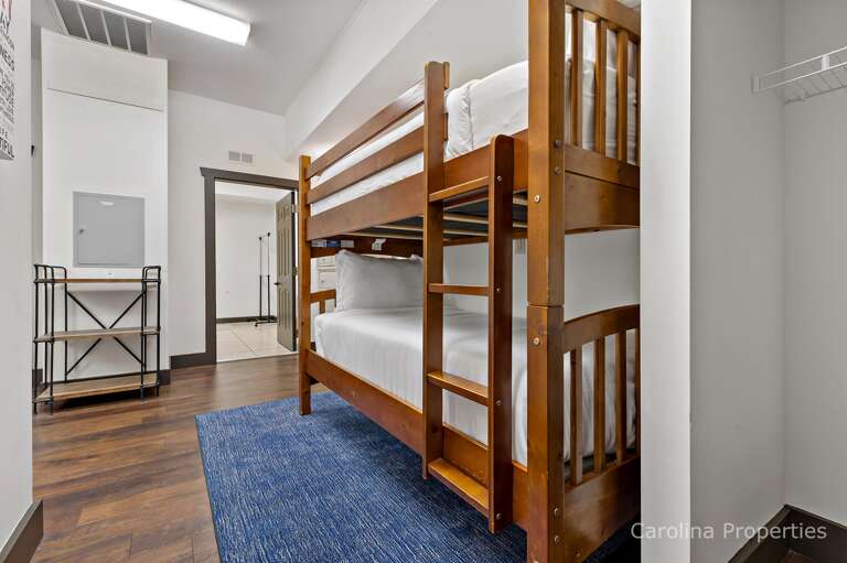 The downstairs room has bunk beds and a dresser