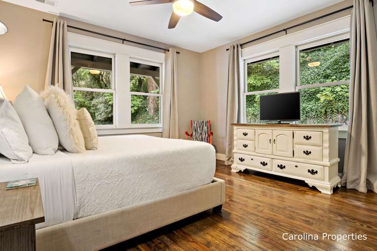 Bedroom 1 has a large dresser and TV