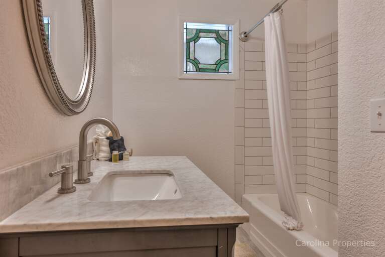 Full bathroom with tub and shower combo on the lower level