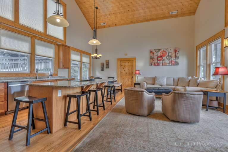 Open concept living area with seating around the kitchen island