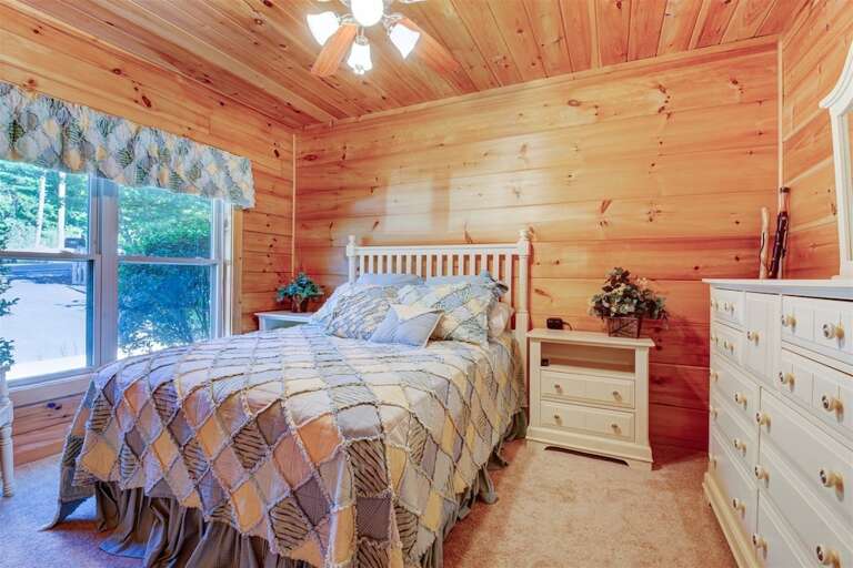 Main level bedroom with queen bed