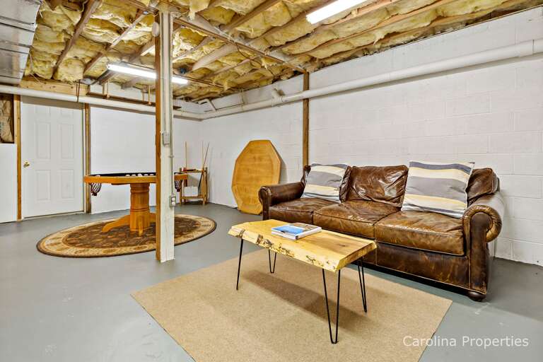 Cozy couch and game table in the basement