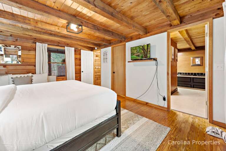 This master bedroom has a TV and private bathroom