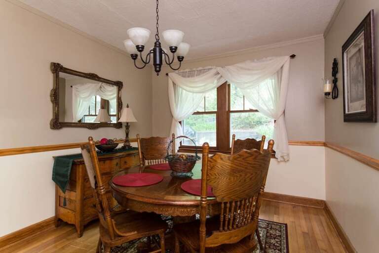 The dining table seats 4. The vintage buffet and mirror add to the ambience of this room.