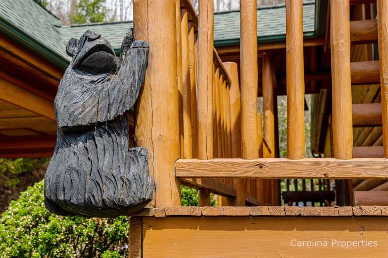Wood bear carving attached to the deck Wood bear carving attached to the deck