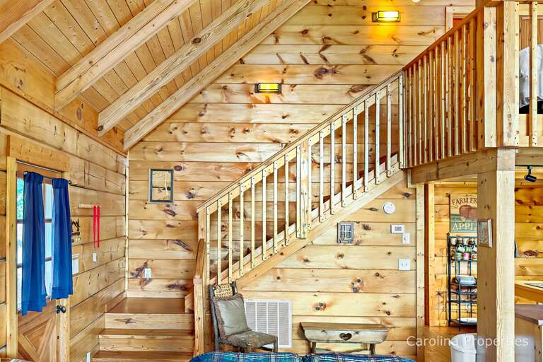 Behind the living room are the steps to the loft area