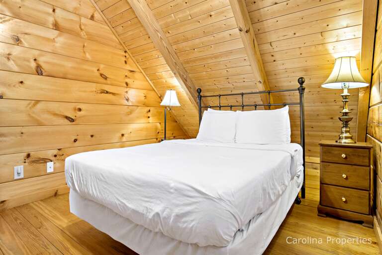 The upper level bedroom has a queen bed