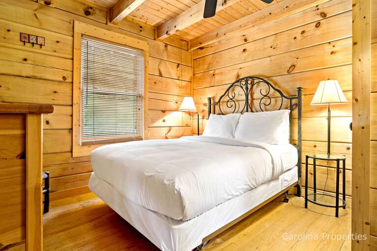 On the main level is a bedroom with a queen bed