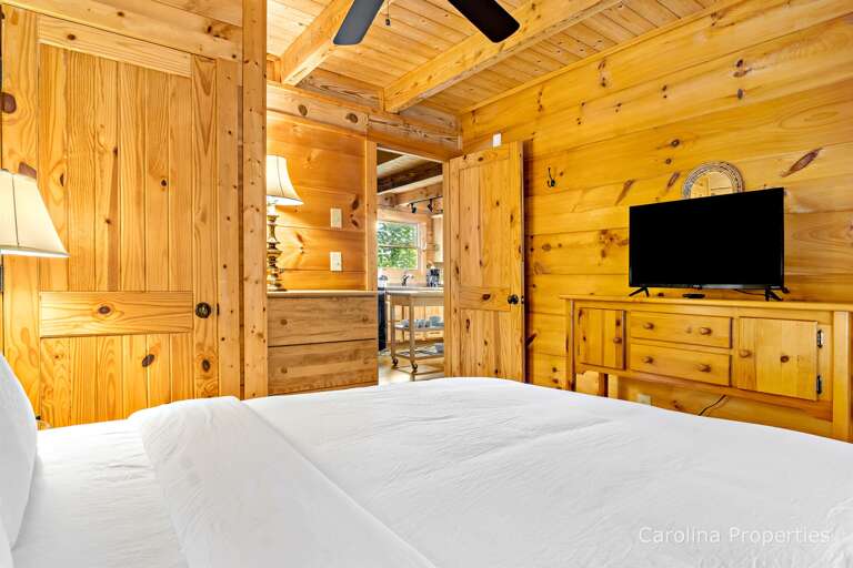 The main level bedroom has a television