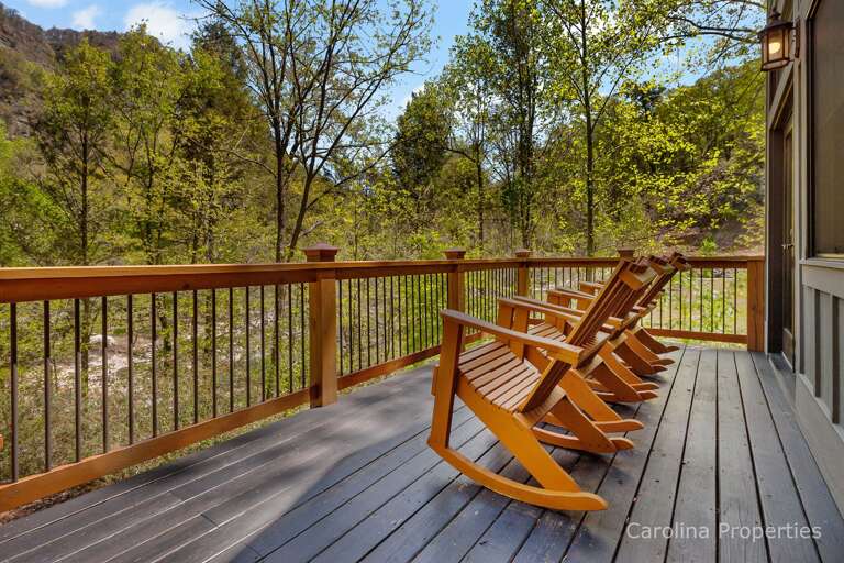 Wooden Adirondack chairs on the deck Wooden Adirondack chairs on the deck