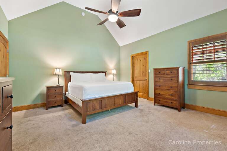 The master bedroom has a king bed, ceiling, fan and windows. The master bedroom has a king bed, ceiling, fan and windows.