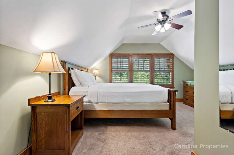 There are side tables with lamps on both sides of the bed There are side tables with lamps on both sides of the bed