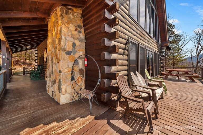 There are chairs, rockers, and hexagon-shaped picnic table