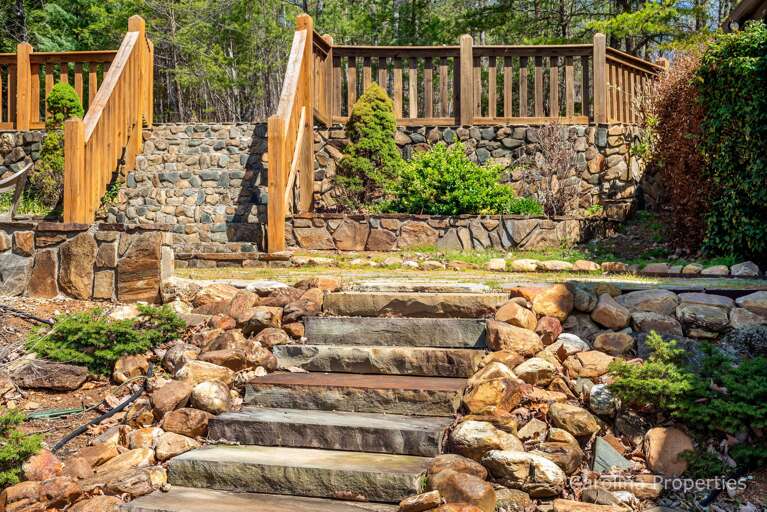 Stairs lead to the sloping back yard