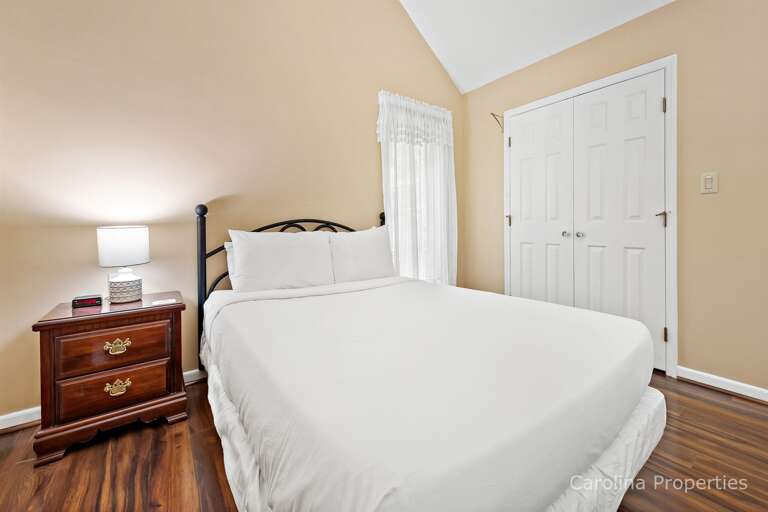 Bedroom has side table and reading lamp