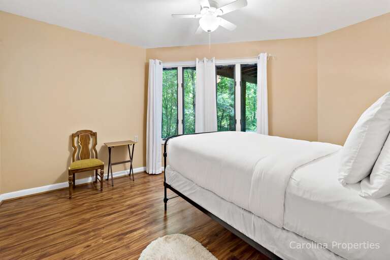 This room has large window and a ceiling fan