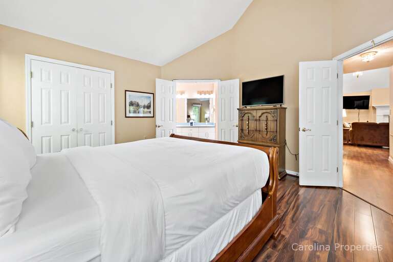 Bedroom has large walk i n closet, dresser and private bathroom