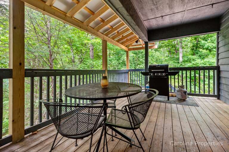 Deck has seating and a gas grill