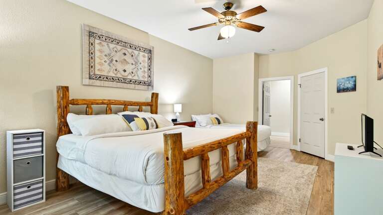 Lower level bedroom with a king size bed and full size bed.