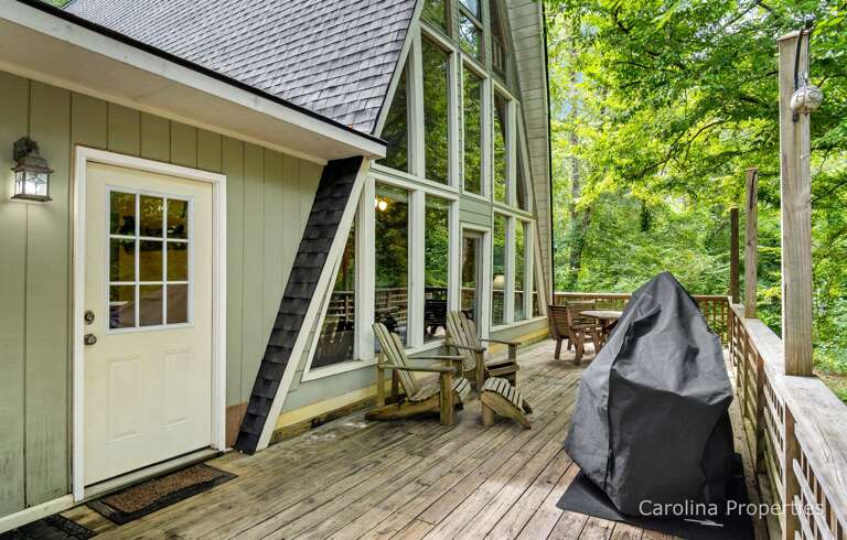 The deck offers plenty of seating options. There is a charcoal grill for your use.