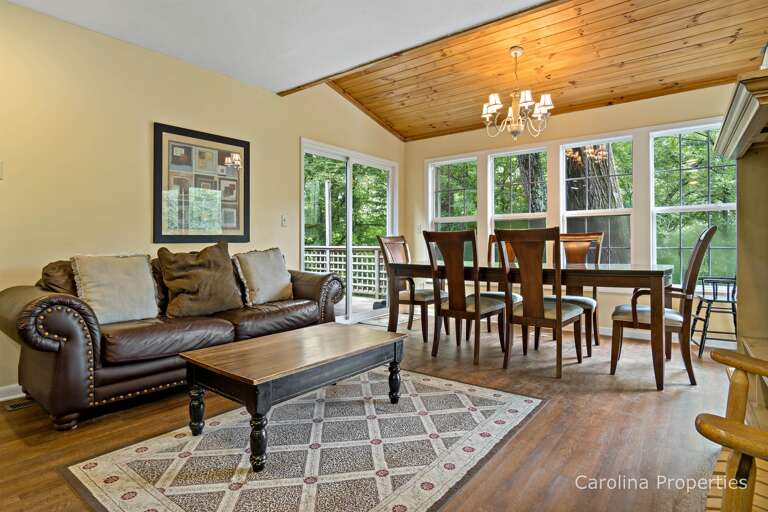 Beyond the family room area is the dining table with seating for 6. Doors here lead to the deck.