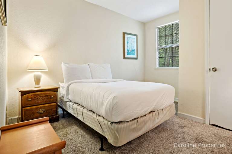 There is a full bed down this short hall.